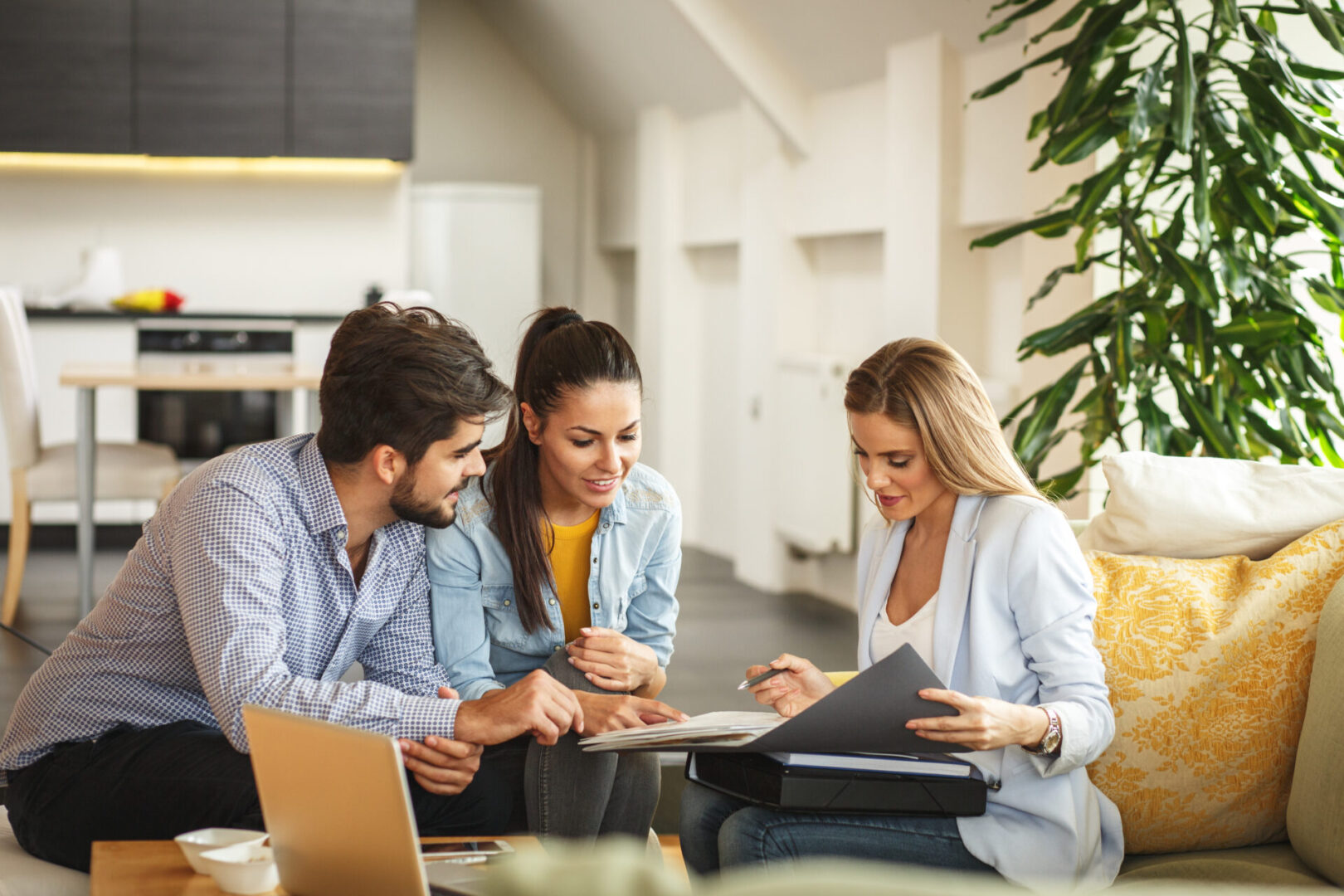 Female Real Estate agent offer home ownership and life insurance to young couple.